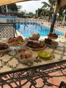 a table with many different types of food on it at Borgo San Biagio in Calatabiano