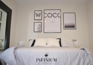 Postel nebo postele na pokoji v ubytování Infinium Zamora Suites
