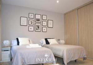 Postel nebo postele na pokoji v ubytování Infinium Zamora Suites