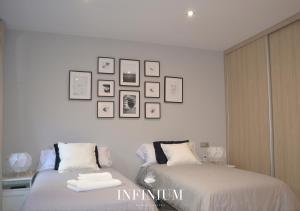 Postel nebo postele na pokoji v ubytování Infinium Zamora Suites