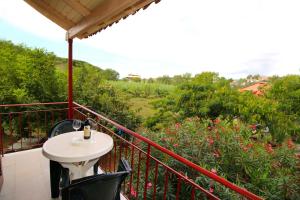 a patio with a table and chairs on a balcony at Romeo & Juliet in Perivolion