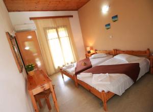 a bedroom with a large bed and a window at Romeo & Juliet in Perivólion