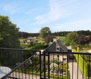 a view from the balcony of a house with a garden at Fletcher Hotel Restaurant Hellendoorn in Hellendoorn