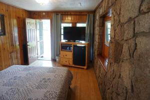a bedroom with a bed and a tv at Marshall's Creek Rest Motel in Gatlinburg