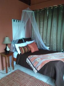 a bedroom with a bed with a mosquito net at Creekside Oasis in Punta Gorda