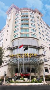 a large building with a sign on the front of it at Grand Arkenso Park View in Semarang