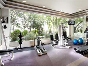 a gym with cardio equipment and a large window at Dorsett Grand Labuan in Labuan