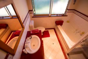 a bathroom with a toilet and a tub and a sink at Jury Road in Meningie