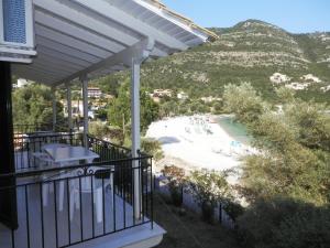 a balcony with a view of a beach at Sea Pebble Studios in Mikros Gialos