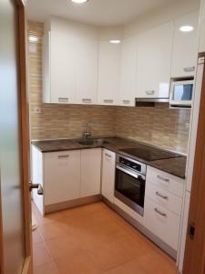 a kitchen with white cabinets and a sink at Calle de Dona Dolsa n6, 2Dcha in Alicante