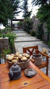 a table with a basket of bread on it at Vernon Villa Stone 1887 in Kastoria