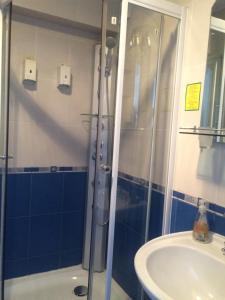 a bathroom with a shower and a sink at Berkana Hotel in Almaty