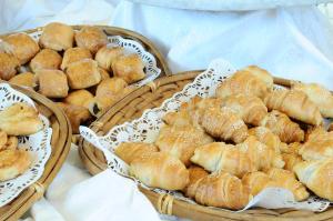 two baskets of bread and pastries on a table at Country Lodge Hotel & Resort Beirut in Beirut