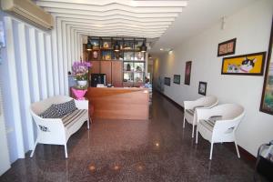 a salon with white chairs and a counter in a room at Kenting Waterfront Hotel in Kenting
