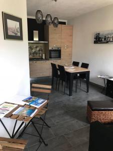 una sala da pranzo con tavolo e sedie e una cucina di Appartamento Rosmarino a Buggerru