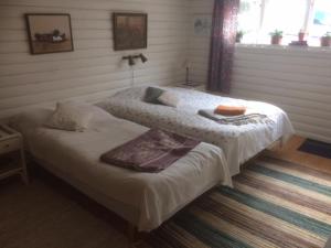 a bedroom with two beds with towels on them at Pilakvarn in Falköping