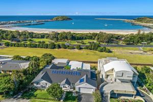 an aerial view of a house with the ocean in the background at Jetty Beach Splendour Apartment in Coffs Harbour