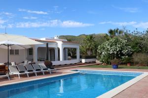 a villa with a swimming pool and a house at Villa Sa Vinyeta in Sant Llorenç de Balafia