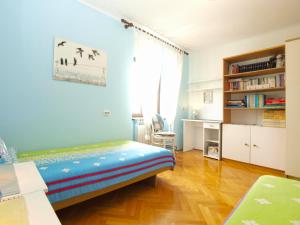 a room with a bed and a desk in it at Apartments Maria 64 in Vodnjan