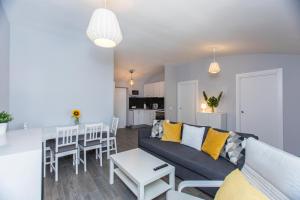 a living room and kitchen with a couch and a table at Casa Alma in Marbella