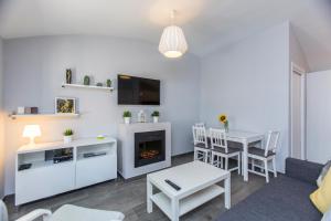a living room with a table and a fireplace at Casa Alma in Marbella