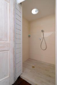 a bathroom with a shower with a shower head at Villa Carmel Boutique Hotel in Haifa