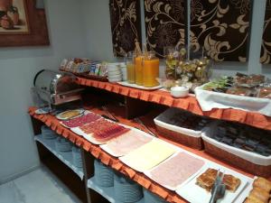 a table topped with plates of food and drinks at Hotel Don Felipe in Segovia