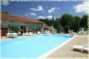 a large swimming pool in front of a building at Hôtellerie de Plein Air Camping Leychoisier in Bonnac-la-Côte