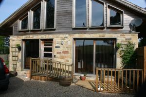 a house with a large glass door and a porch at Crackin View Holiday cottage in Hexham