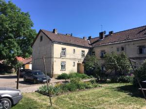 an old house with a car parked in front of it at Vintage Design Apartment in Kuldīga