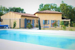 a house and a swimming pool in front of a house at Terre de Sel in Grimaud