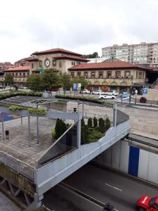 a pedestrian bridge over a street in a city at Hostal González in Oviedo