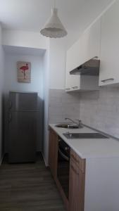 a kitchen with a sink and a refrigerator at Flamingo in Šibenik