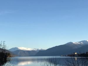 a view of a lake with mountains in the background at Villa Holmen, ground floor apartment in Balestrand