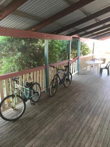 two bikes parked on a wooden deck at STORK RD BUDGET ROOMS - PRIVATE ROOMS WITH SHARED BATHROOMS access to POOL in Longreach