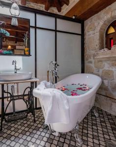 a bathroom with a bath tub and a sink at Villa Galanoussa in Zakynthos +32 photos