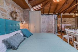 a bedroom with a bed with a blue head board at Villa Galanoussa in Zakynthos Town