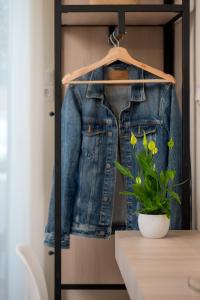 a denim jacket hanging in a closet with a plant at Apollo Philoxenia in Plakias