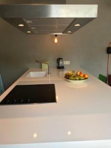 a kitchen with a bowl of fruit on a counter at Villa Pats in Gilze