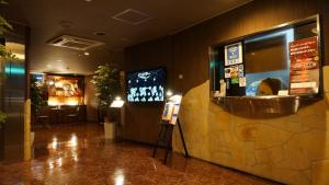 a restaurant lobby with a bar and a restaurant sign at Hotel Jupiter (Adult Only) in Hiroshima