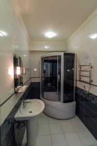 a bathroom with a sink and a shower and a mirror at Hotel Т2 in Kyiv