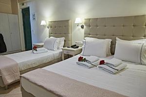 a hotel room with two beds with flowers on them at Element Hotel in Elafonisos