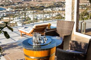 a patio with a table and chairs on a balcony at Amazing Sea View Villa in Parikia