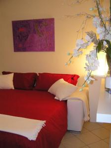 1 dormitorio con cama roja y mesa en Atelier, en Portogruaro