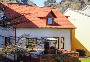 a house with an orange roof at Lava Guesthouse in Vestmannaeyjar