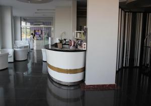 a lobby with a bar in the middle of a building at Orient House in Hail
