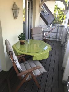 a green table and chairs on a balcony at Julia in Zingst