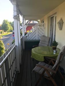 a balcony with a table and chairs on a porch at Julia in Zingst