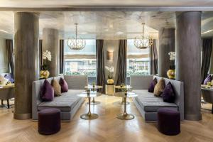 a lobby with two couches and two tables and windows at Rosa Grand Milano - Starhotels Collezione in Milan