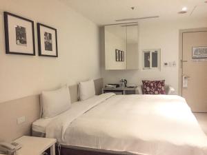 Voodi või voodid majutusasutuse Wemeet Hotel Taipei toas